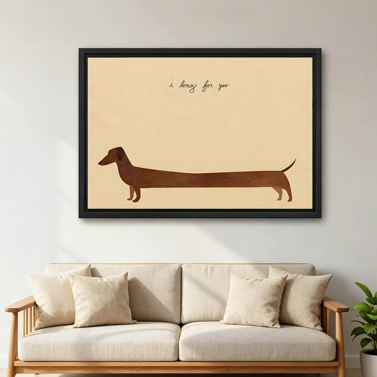 Dachshund I long for you minimalist cream background long brown dachshund silhouette black framed canvas wall art on light gray wall above wide cream linen sofa with wood armrests and tropical green plant