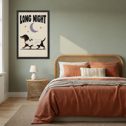 Dachshund Long Night canvas wall art in a black frame decorates a bedroom wall above the bed.