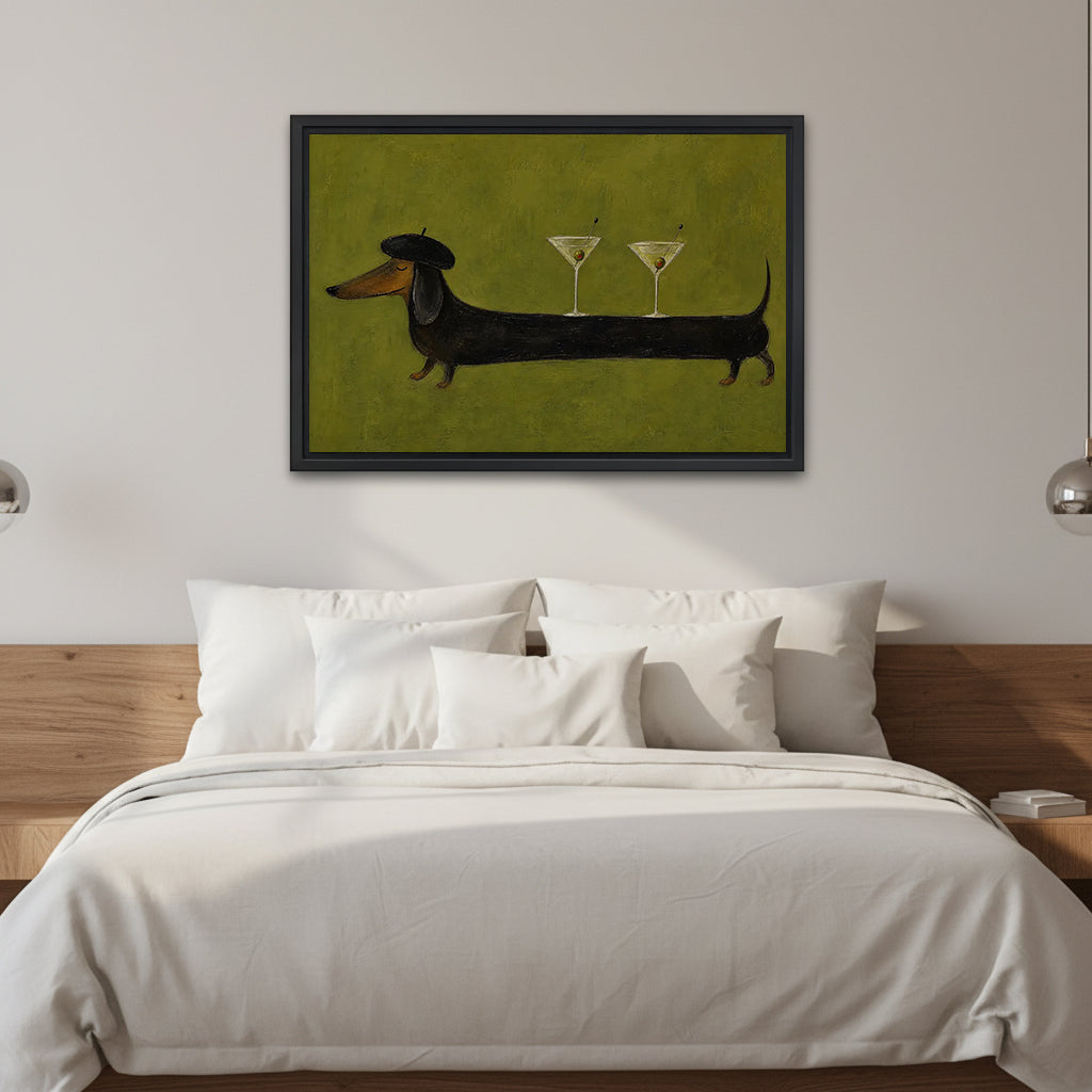 Dachshund martini canvas wall art in a black frame above a white bed with a wooden headboard