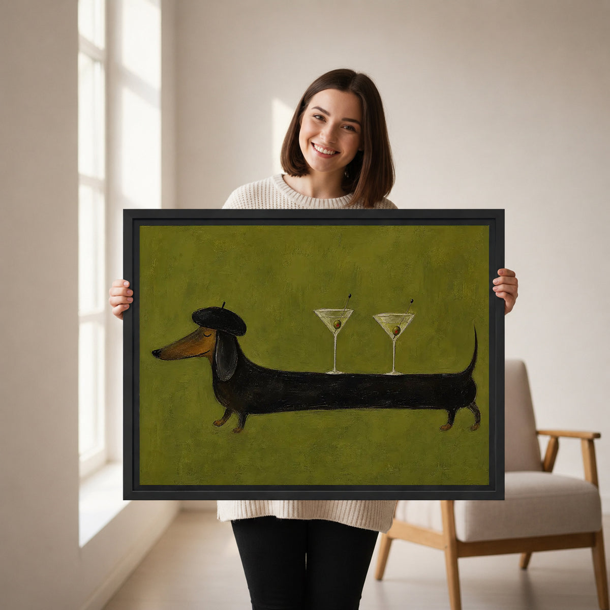 Woman holding framed dachshund martini canvas wall art featuring a beret-wearing dog balancing two cocktail glasses