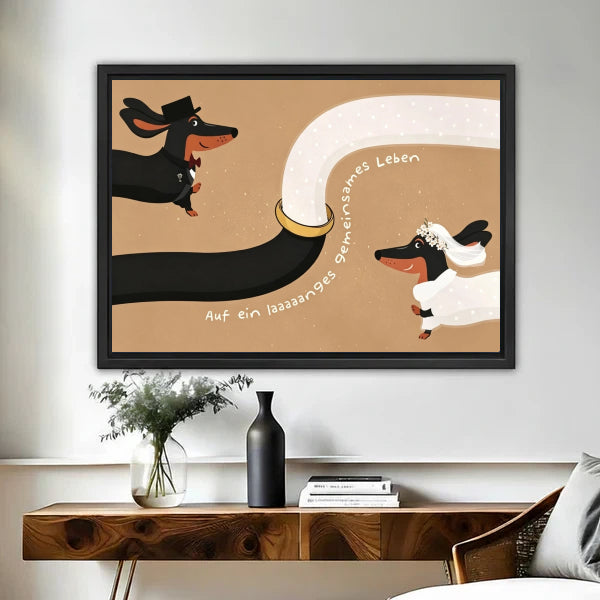 Whimsical dachshund bride and groom wedding framed canvas print displayed above wooden console table with vases in entryway