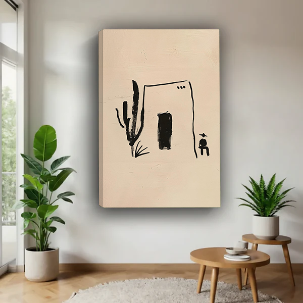 Framed desert house and cactus canvas wall art on beige displayed between potted plants above wooden nesting tables.