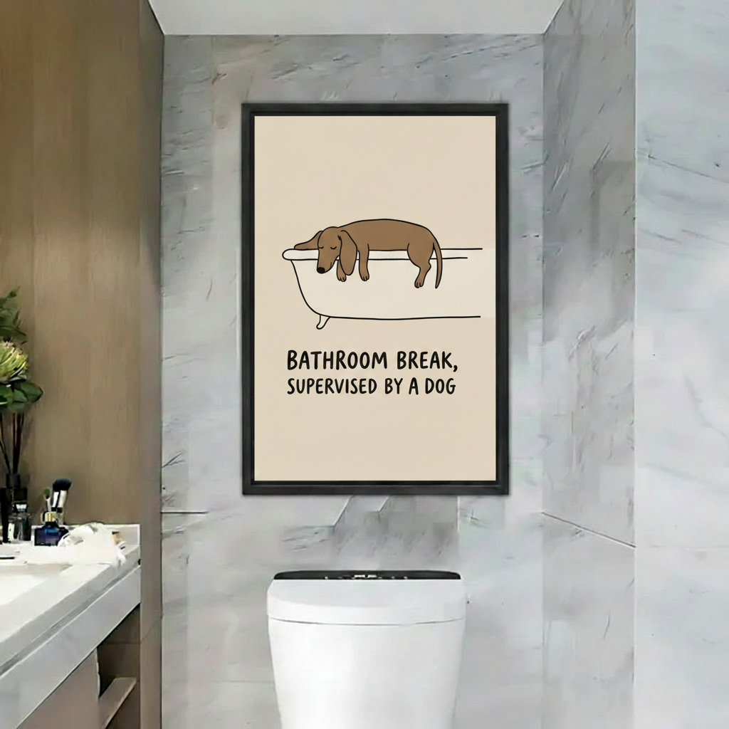 Framed canvas wall art of dachshund draped over bathtub with text Bathroom Break Supervised by a Dog, marble bathroom