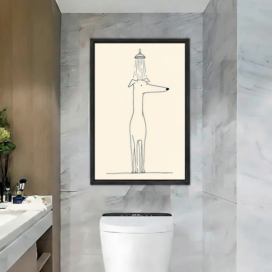 Minimalist dog in shower canvas wall art in a black frame, displayed above a toilet against gray marble walls.