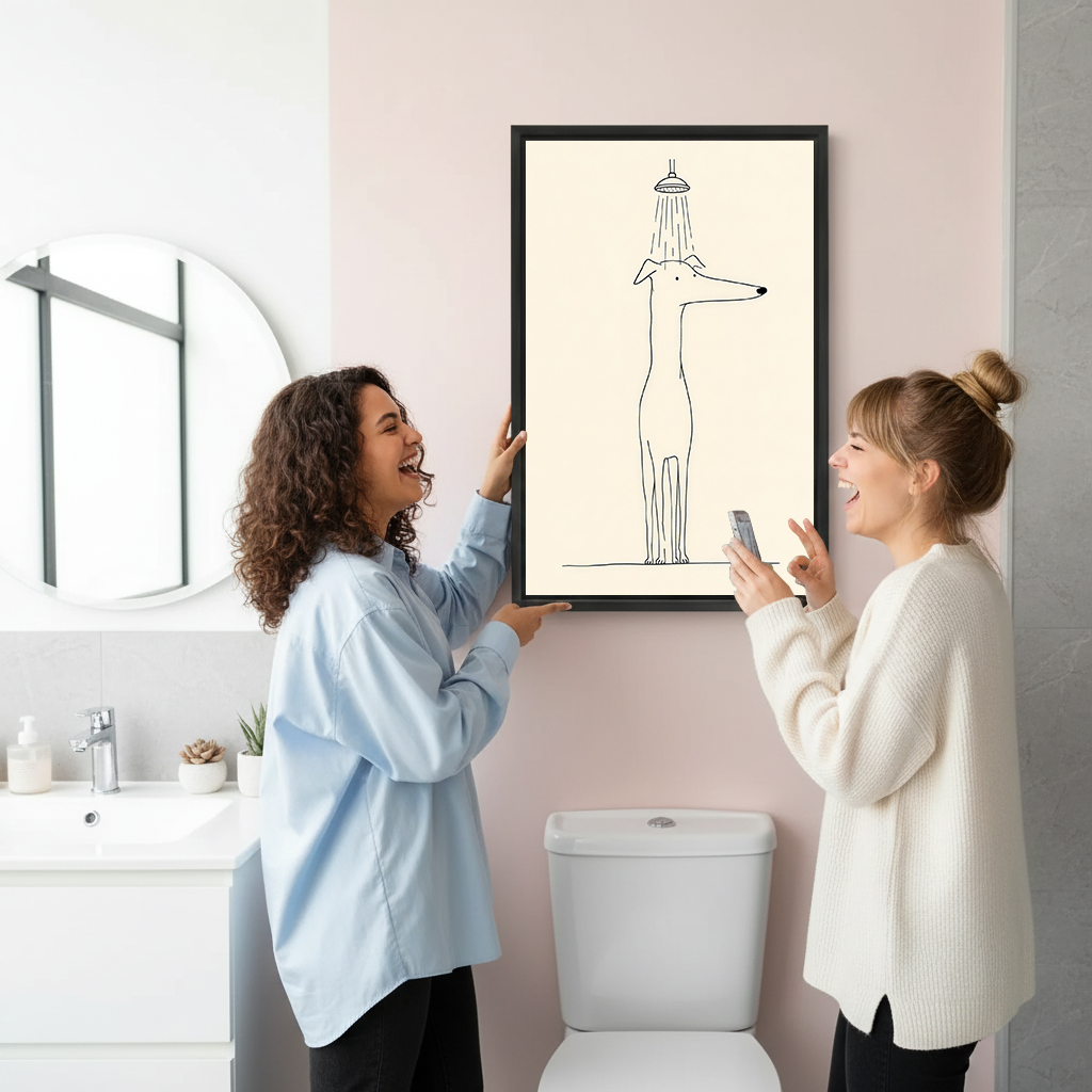 Dog in shower canvas wall art in a black frame beside two laughing women in a pink bathroom.