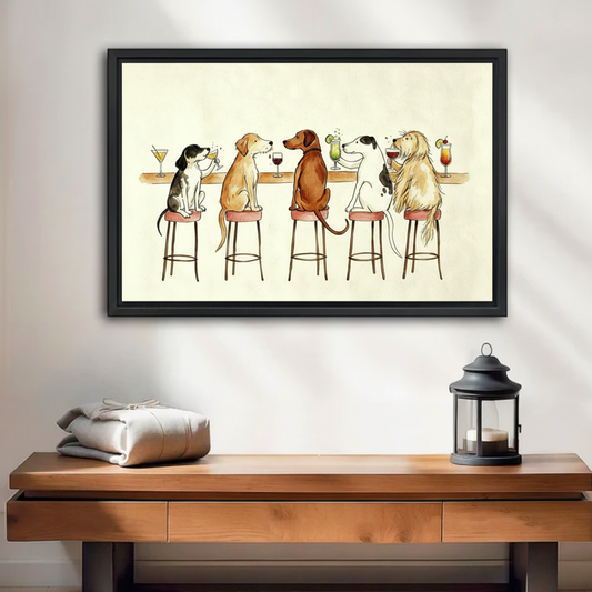 Framed canvas print of five dogs sitting at a bar drinking cocktails, displayed above a wooden console table with lantern decor