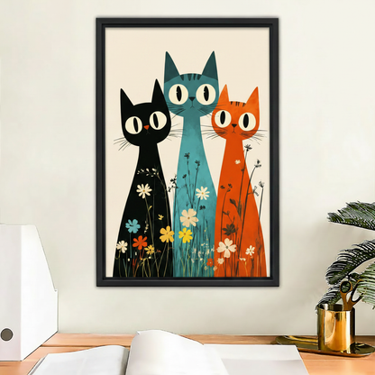 Three cats with wildflowers mid-century modern framed canvas print displayed above wooden desk – colorful wall art