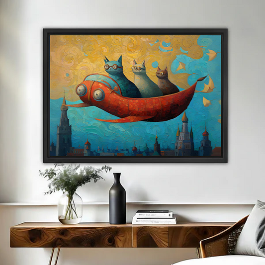 Fantasy framed wall art of three cats in glasses riding a giant red flying fish over a magical city skyline, hung above a wooden console table