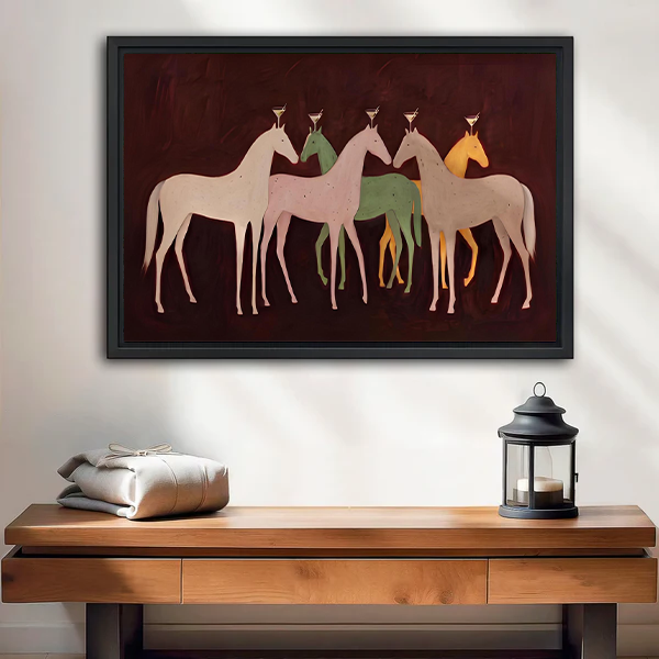 Folk art five horses canvas wall art in a black frame above a wooden console with a lantern.
