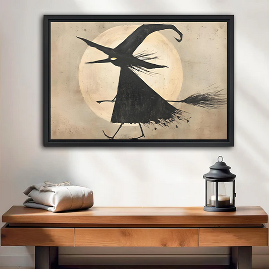 Flying witch moon canvas wall art displayed above a wooden console with a lantern in a bright room