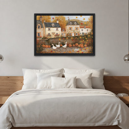 Black-framed folk art autumn village wall art above a bed with white bedding and a wooden headboard.