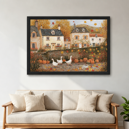 Framed folk art autumn village wall art above a cream sofa with wooden arms beside a leafy plant.