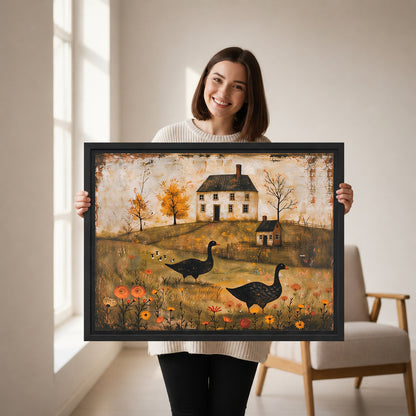 Woman holding framed folk art black geese canvas wall art with two geese, autumn trees, flowers, and a farmhouse.