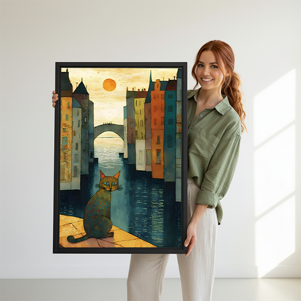Smiling woman holding large black framed folk art cat Venice canal canvas print to show size