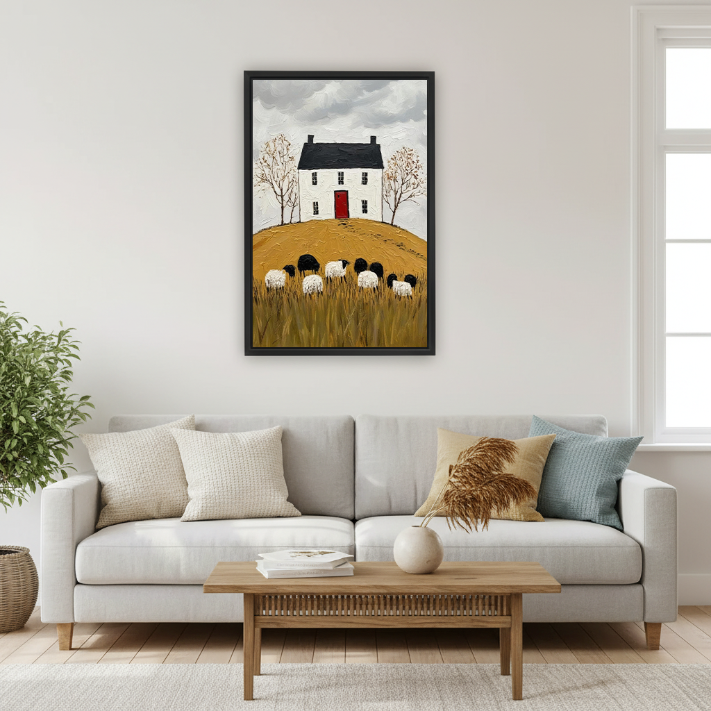 Black-framed cottage and sheep canvas wall art featuring a red door and golden meadow beside a bed.
