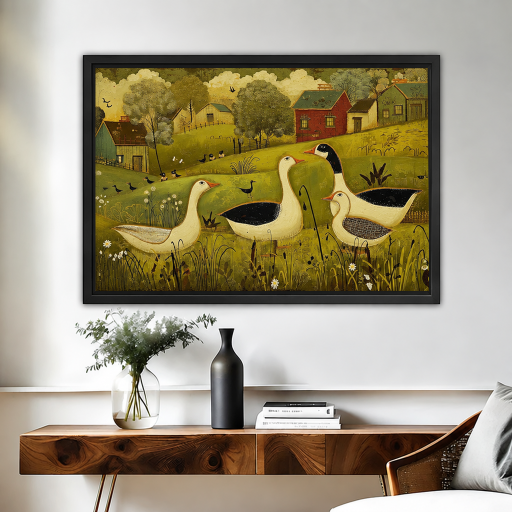 Black-framed folk art country geese canvas wall art above a wooden console with vases and books.
