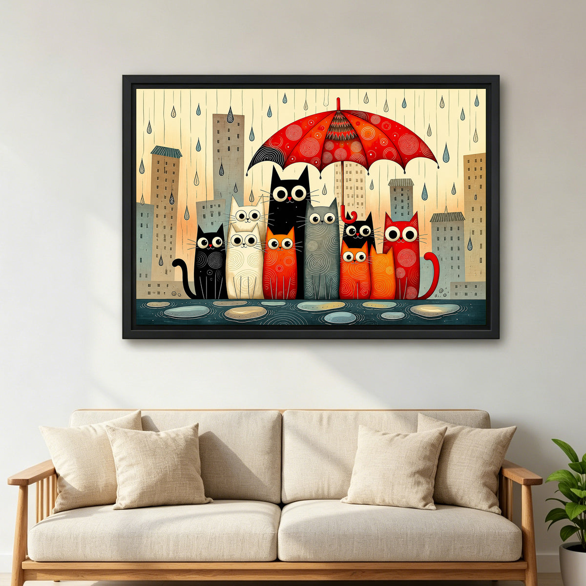 Large framed folk art rainy cats wall art hanging above a beige sofa with cushions