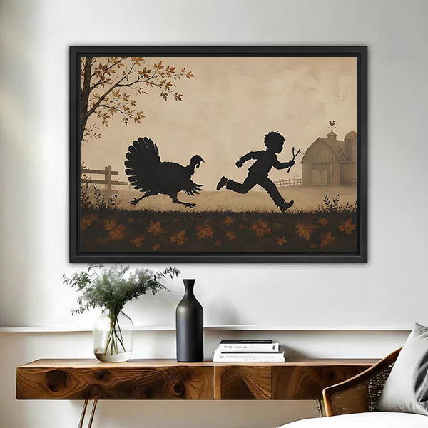 Folk art turkey chase canvas wall art in black float frame above wooden console, boy and turkey silhouette on autumn farm, warm sepia tones