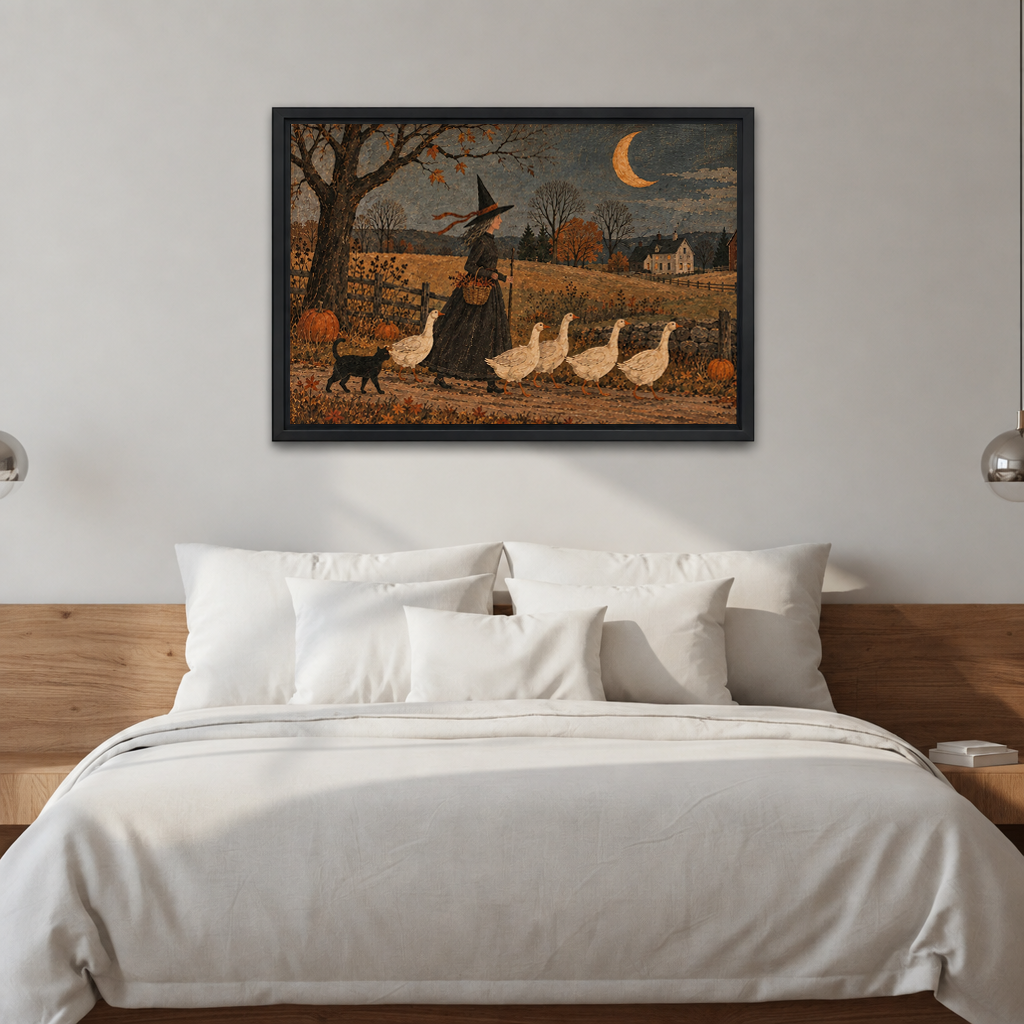 Black-framed folk art witch and geese wall art above white bedding and a wooden headboard in a bright bedroom.