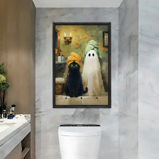 Framed black cat ghost Halloween canvas wall art displayed above a bathroom console with plants and a round mirror