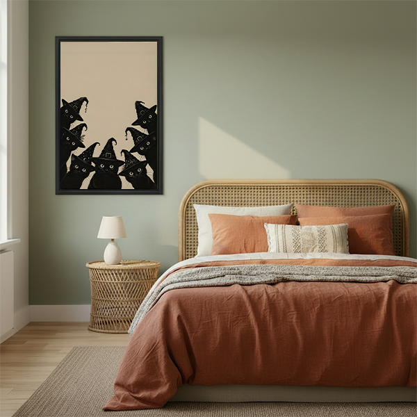 Framed black cat Halloween canvas wall art with witch hat cats above a warm neutral bed