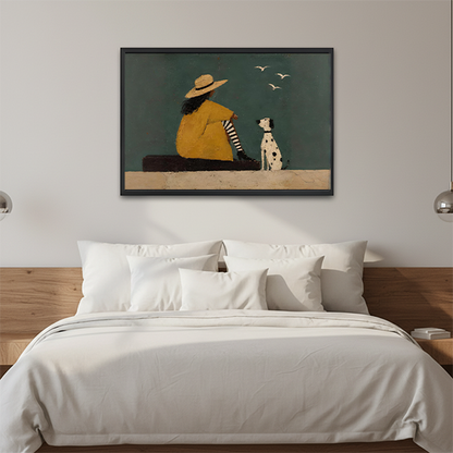 Framed contemporary woman and dog wall art displayed above a neutral sofa with cushions.
