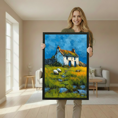Woman holding framed country cottage and sheep canvas wall art to demonstrate its vertical size and appearance.