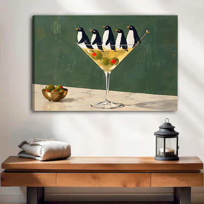 Framed penguin martini canvas wall art hanging above a wooden console with a black lantern.