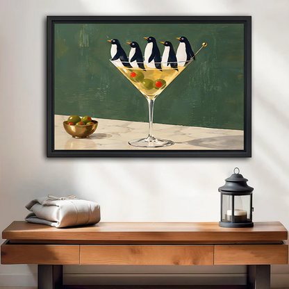 Framed penguin martini canvas wall art displayed above a cream sofa in a bright living room.