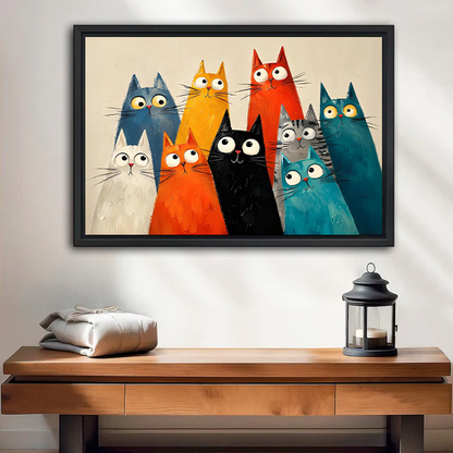 Framed quirky cats canvas wall art hung above a white bed with layered pillows in a calm bedroom.