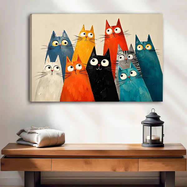 Framed quirky cats canvas wall art above a wooden entryway bench with a black lantern and linens.