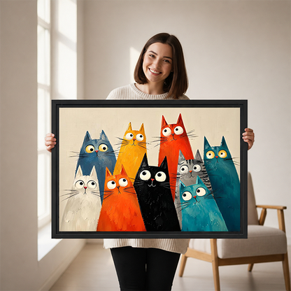 Smiling woman holding framed quirky cats canvas wall art showing the print size in a bright room.