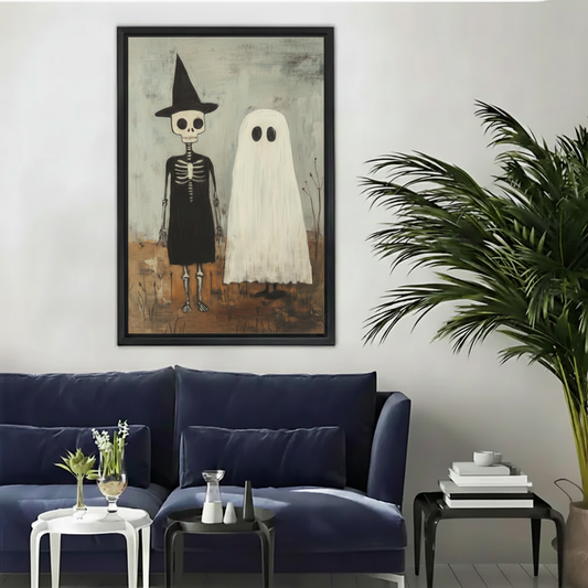  Framed witch and ghost Halloween canvas wall art displayed above a modern dark blue living room sofa.