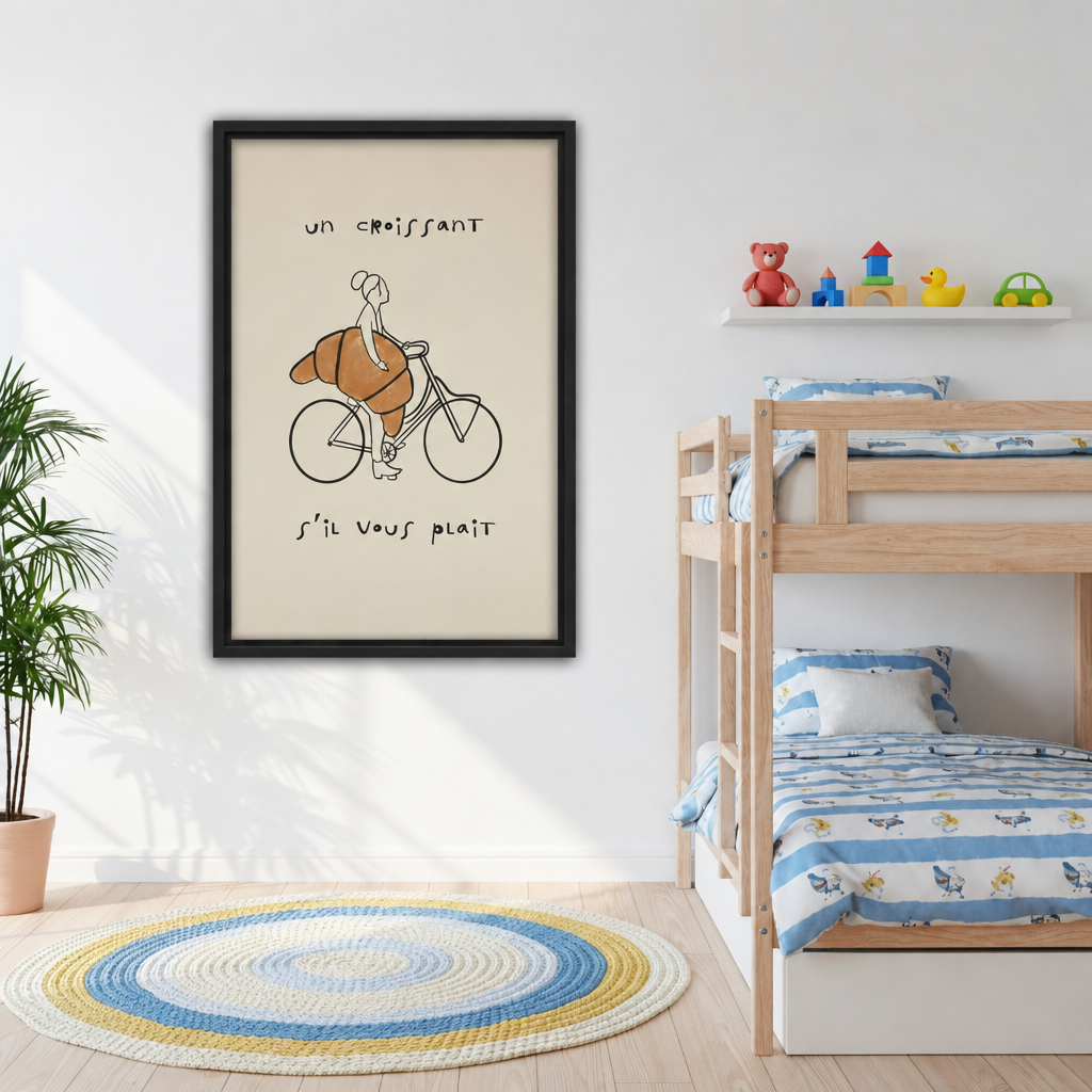 Framed canvas of whimsical line drawing of a woman riding a bicycle with an oversized golden croissant and French quote on cream background beside kids bunk bed with colorful striped bedding