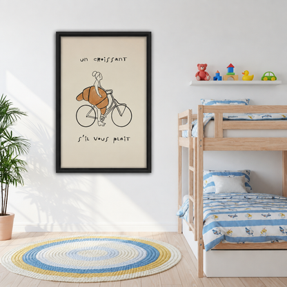 Framed canvas of whimsical line drawing of a woman riding a bicycle with an oversized golden croissant and French quote on cream background beside kids bunk bed with colorful striped bedding
