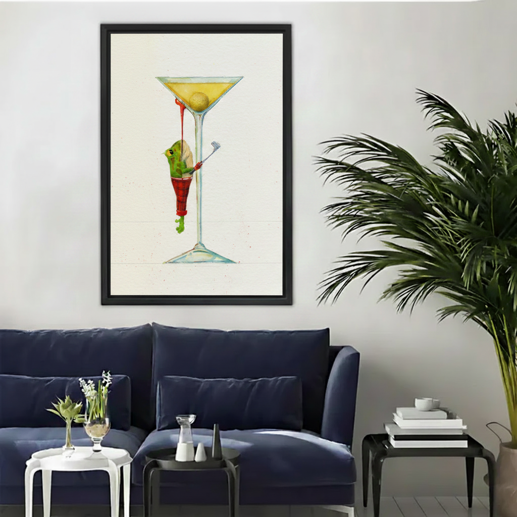 Whimsical frog martini framed canvas wall art hung above navy sofa as main product lifestyle display