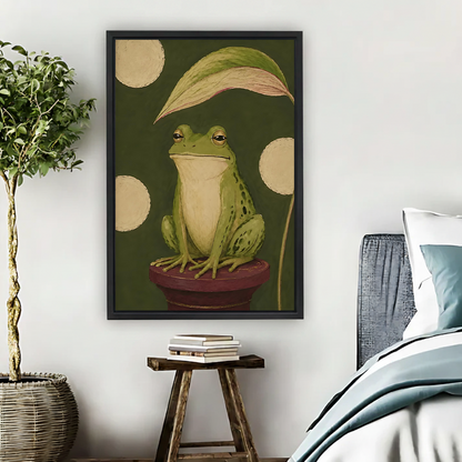 Vintage frog portrait canvas wall art in a black frame displayed above a bedside table and plant