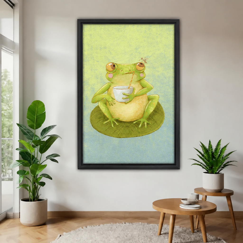 Frog sipping canvas wall art in a black frame shows a green frog holding a cup while sitting on a lily pad.
