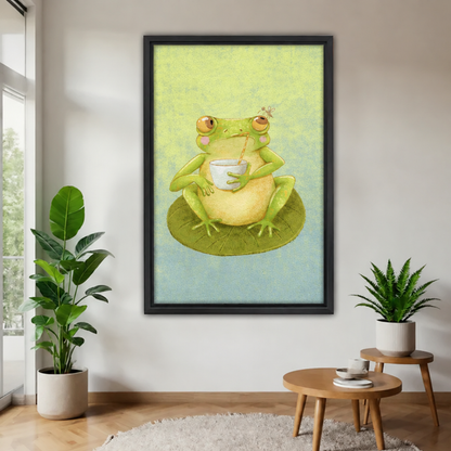 Frog sipping canvas wall art in a black frame shows a green frog holding a cup while sitting on a lily pad.