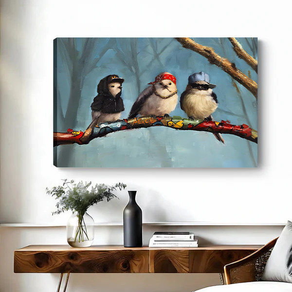 Canvas art print of three funky birds wearing hip-hop outfits perched on a colorful branch, displayed above a wooden console table