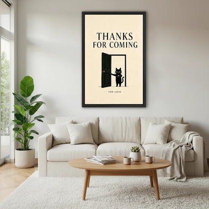 Humorous black cat now leave framed canvas above cream sofa in bright Scandinavian living room with coffee table