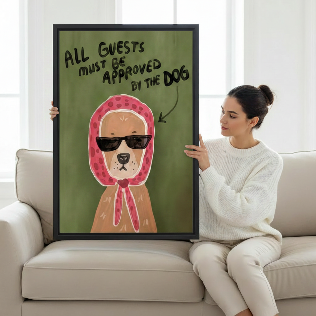 Woman holding large funny dog All Guests Must Be Approved By The Dog framed canvas print on white sofa showing artwork scale