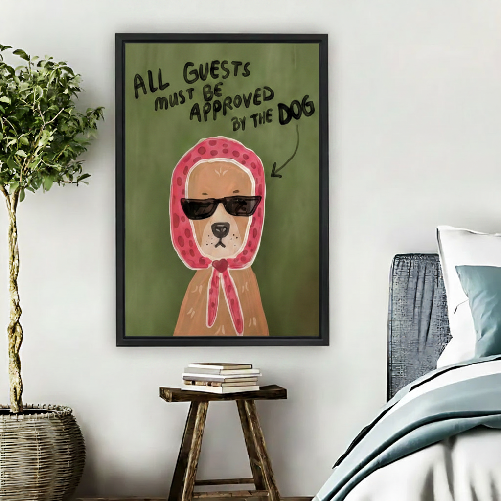 Funny dog wearing sunglasses and pink polka dot headscarf framed canvas wall art hung in cozy bedroom beside wooden stool and indoor plant