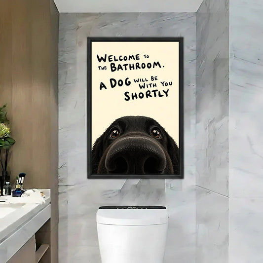 Funny dog bathroom quote welcome black labrador nose cream black framed canvas wall art on gray marble tile wall above white toilet beside marble vanity with makeup brushes