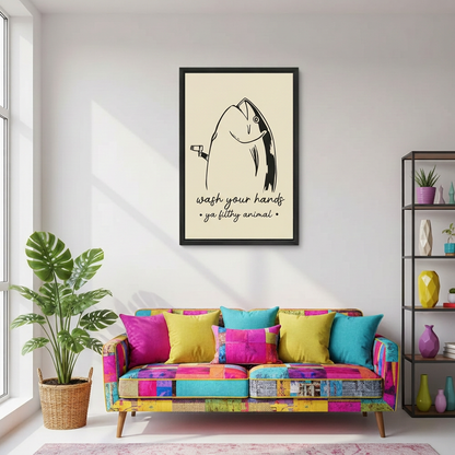 Black-framed funny fish wall art displayed above a colorful patchwork sofa in a bright living room.