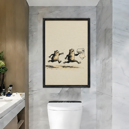 Black-framed funny frog canvas wall art featuring two running frogs above a toilet in a gray bathroom.