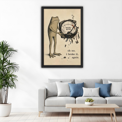 Framed funny frog Weird Meter canvas wall art hangs above a light sofa with blue cushions.
