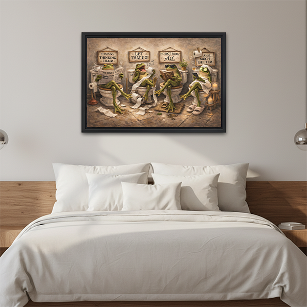 Whimsical frogs bathroom canvas wall art in a black frame above a cream sofa with neutral cushions.