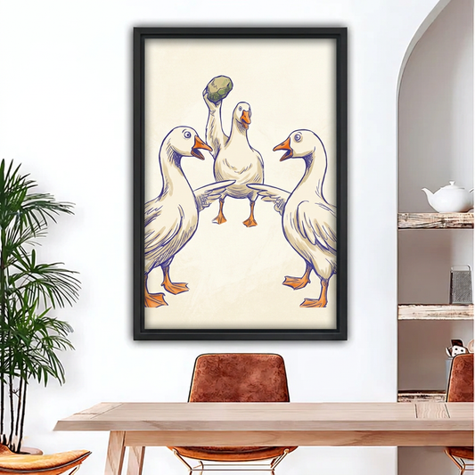 Framed funny geese canvas above a wooden dining table.