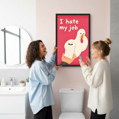 Two women admire framed funny goose bathroom canvas wall art on a pink wall above a toilet.